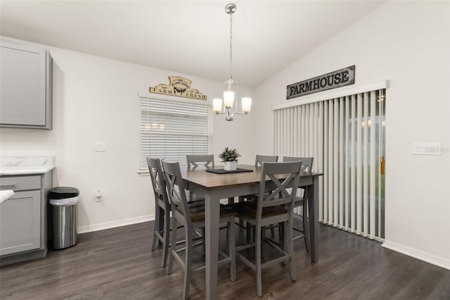 dining room featuring a chandelier, vaulted ceiling, and dark hardwood / wood-style floors