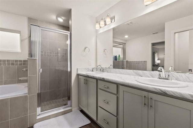 bathroom with independent shower and bath and vanity