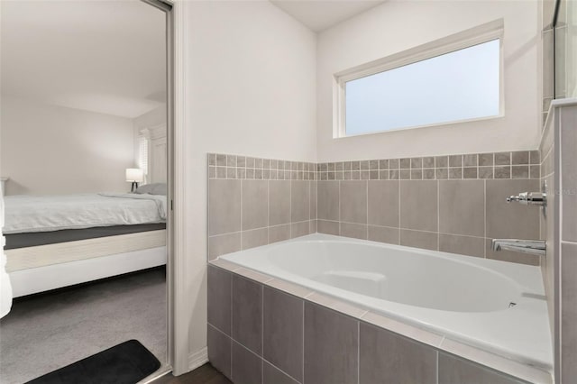 bathroom featuring tiled tub