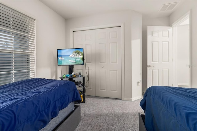 carpeted bedroom with a closet