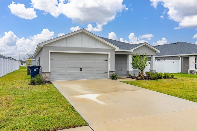 view of front facade with central AC unit, a garage, and a front lawn