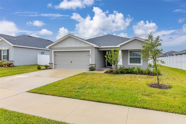 ranch-style home featuring a front lawn and a garage