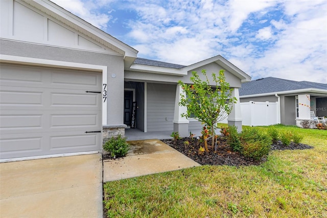 view of front of home with a front lawn and a garage