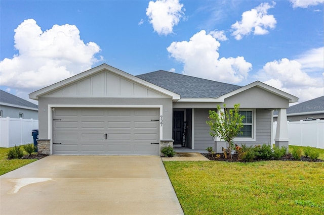 single story home featuring a garage and a front yard