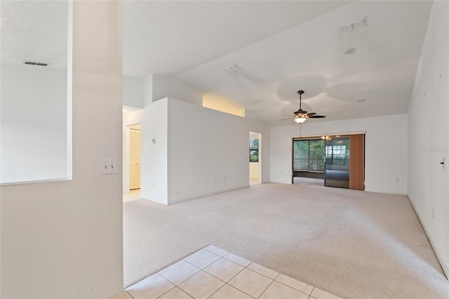 unfurnished living room featuring light carpet, ceiling fan, and vaulted ceiling