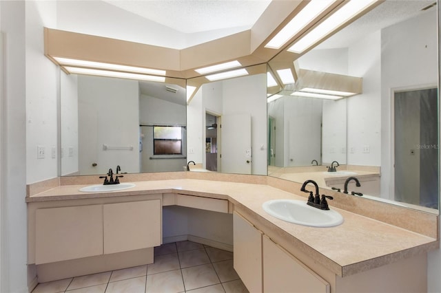 bathroom featuring vanity, tile patterned flooring, a textured ceiling, and vaulted ceiling