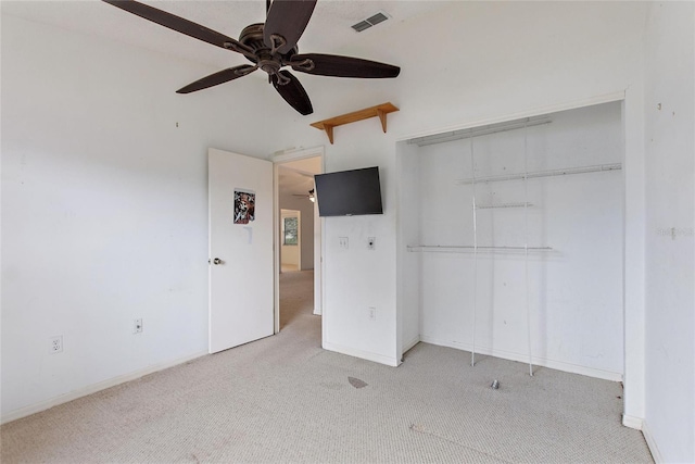 unfurnished bedroom with a closet, light carpet, and ceiling fan