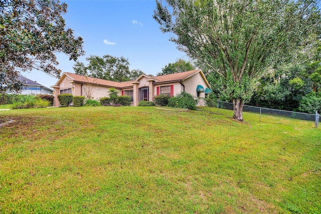 ranch-style home featuring a front lawn