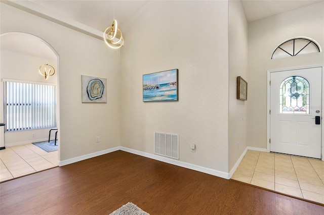 9016 Murano Mews Ct, Kissimmee, FL 34747 - entrance foyer with wood finished floors, arched walkways, and baseboards