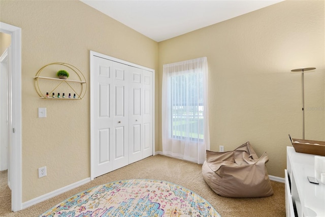 bedroom with light carpet and a closet