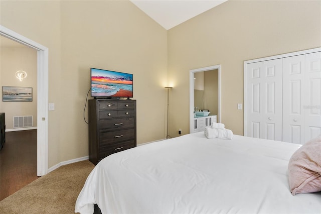 bedroom featuring high vaulted ceiling, a closet, and carpet flooring