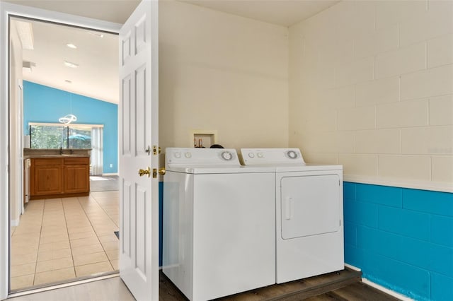 laundry area with washing machine and dryer and tile patterned flooring