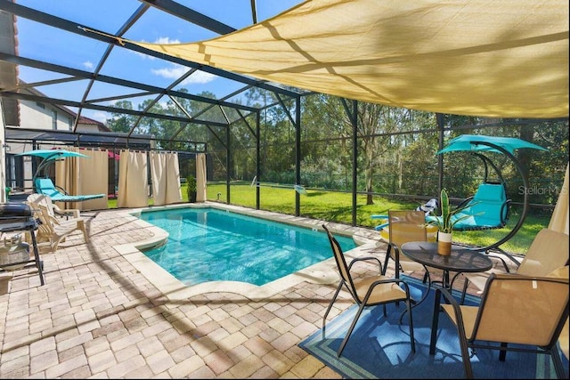 view of swimming pool with a lanai, a yard, and a patio area