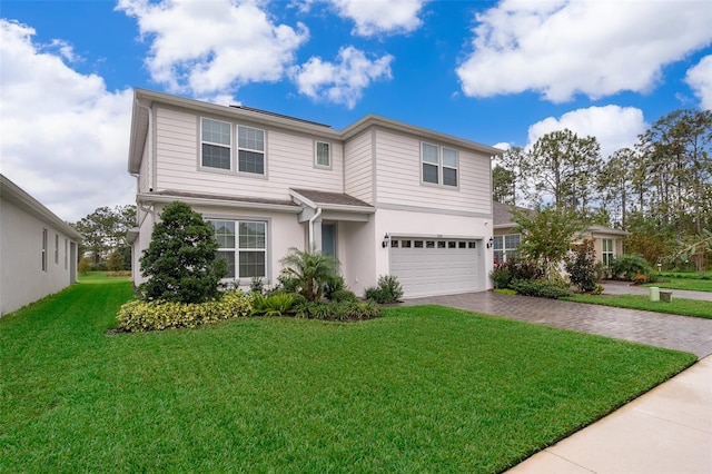 view of property featuring a garage and a front yard