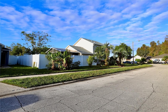 view of side of home with a yard