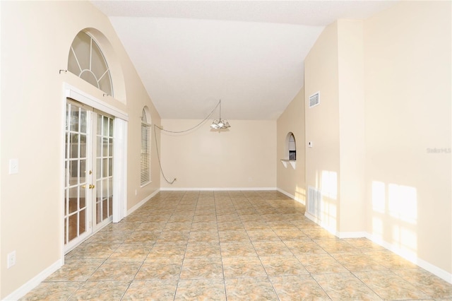 spare room featuring high vaulted ceiling