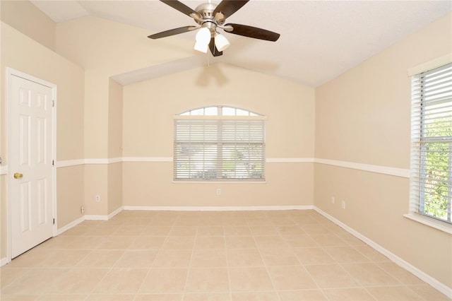 unfurnished room featuring lofted ceiling, a healthy amount of sunlight, ceiling fan, and light tile patterned floors