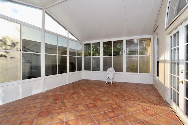 unfurnished sunroom featuring vaulted ceiling