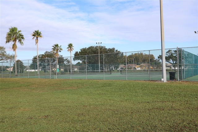 view of sport court with a yard