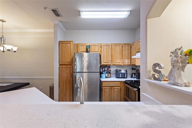 kitchen featuring black electric range, pendant lighting, and stainless steel refrigerator