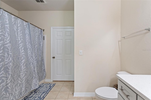 bathroom featuring toilet, vanity, and tile patterned floors