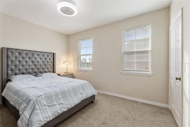 bedroom featuring multiple windows and carpet flooring