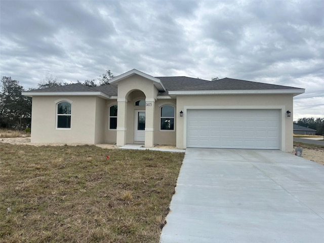 view of front facade with a front yard and a garage