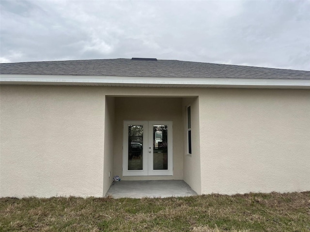 entrance to property with french doors and a yard