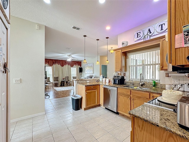 kitchen featuring pendant lighting, sink, stainless steel dishwasher, kitchen peninsula, and ceiling fan