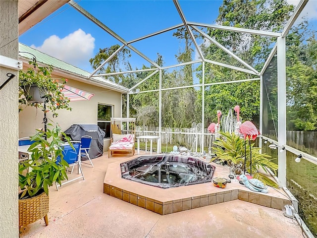 view of patio / terrace with a lanai, a grill, and a fire pit