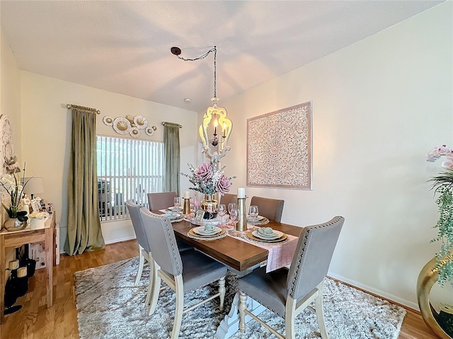 dining room featuring a chandelier and wood-type flooring