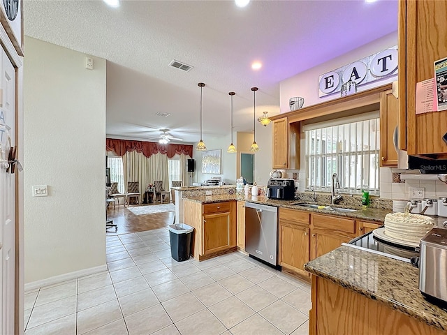 kitchen with sink, kitchen peninsula, ceiling fan, hanging light fixtures, and dishwasher