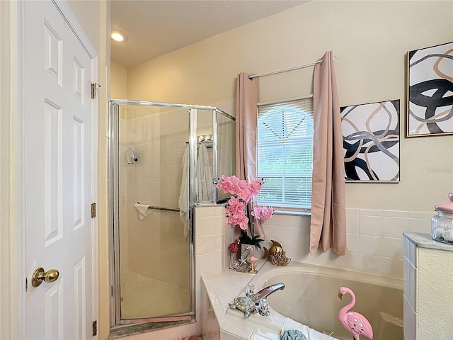 bathroom featuring separate shower and tub