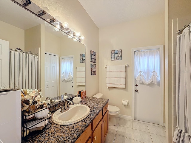 bathroom featuring toilet, a shower with curtain, vanity, and tile patterned flooring