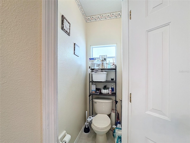 bathroom with toilet and tile patterned floors