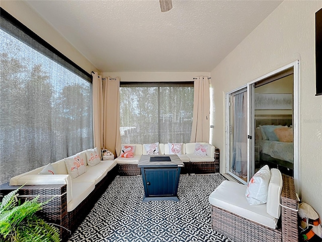 sunroom / solarium featuring ceiling fan