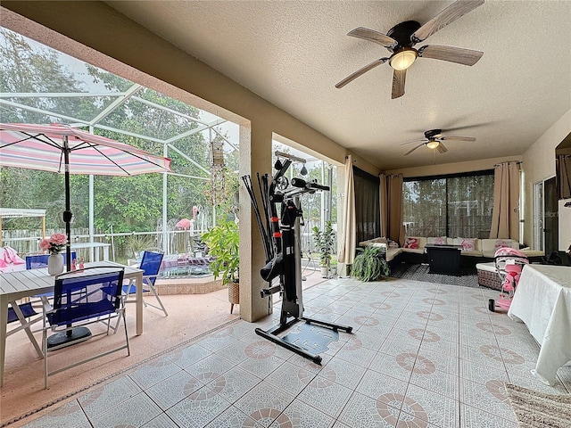 exterior space with an outdoor living space, a lanai, and ceiling fan