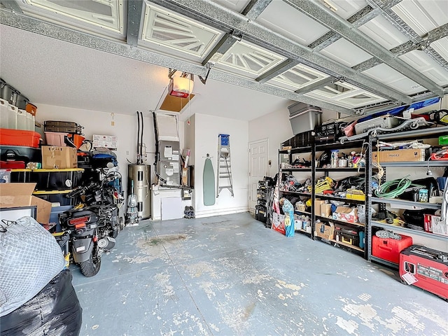 garage featuring heating unit, water heater, and a garage door opener