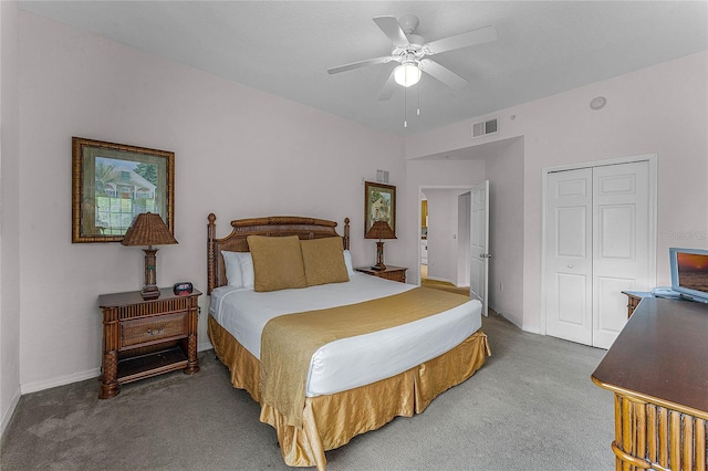 carpeted bedroom with ceiling fan and a closet