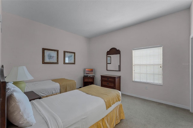 bedroom featuring light carpet