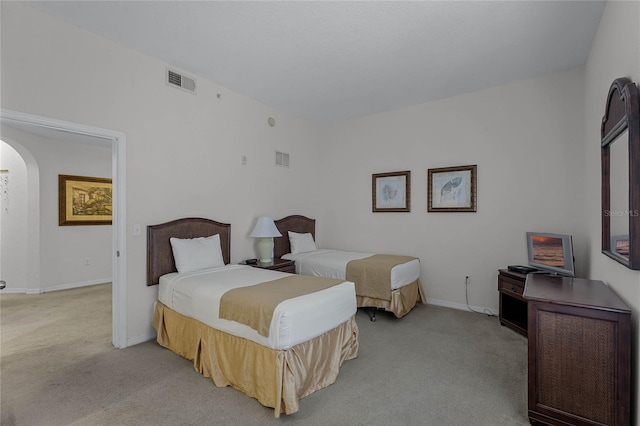 bedroom featuring light colored carpet