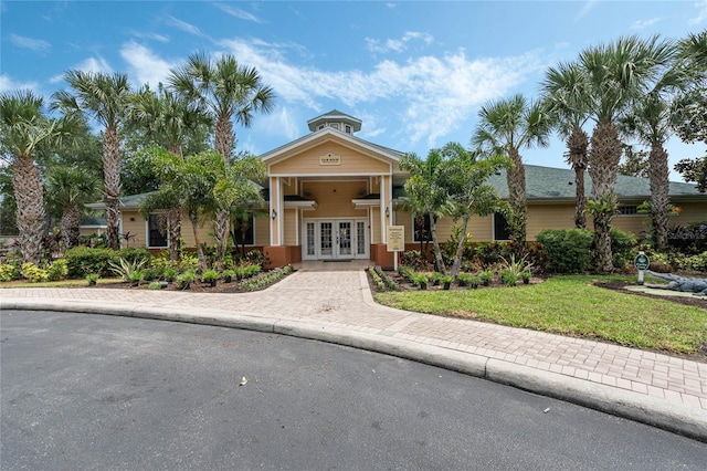 view of front of property featuring a front lawn and french doors