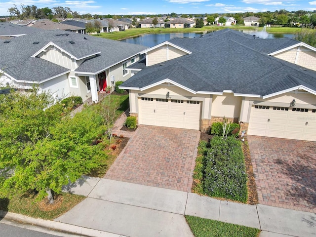 view of front facade with a garage and a water view