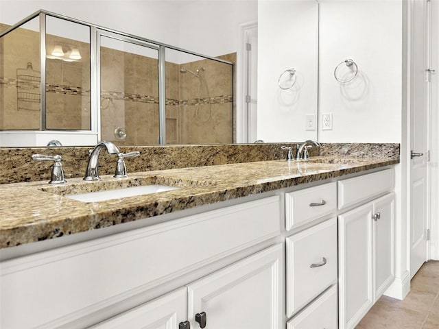 bathroom with walk in shower, tile patterned flooring, and vanity