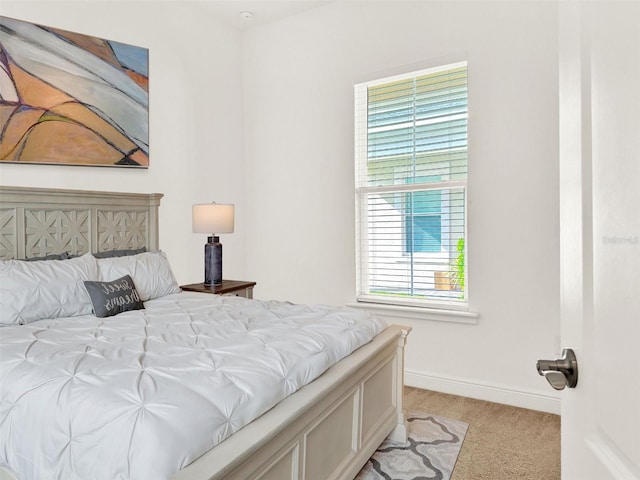 bedroom featuring multiple windows and light carpet