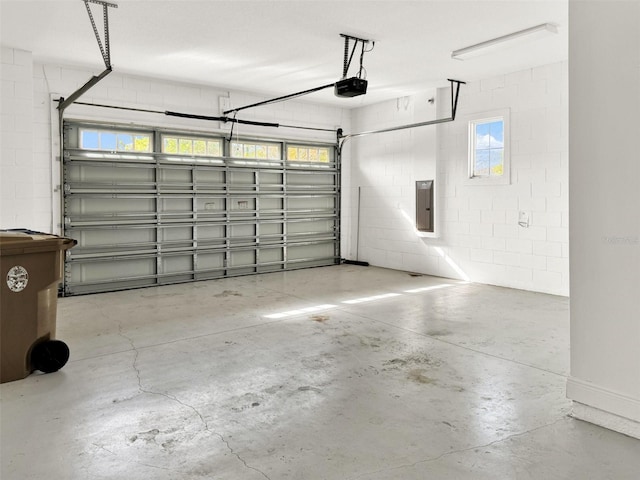 garage with a garage door opener and electric panel