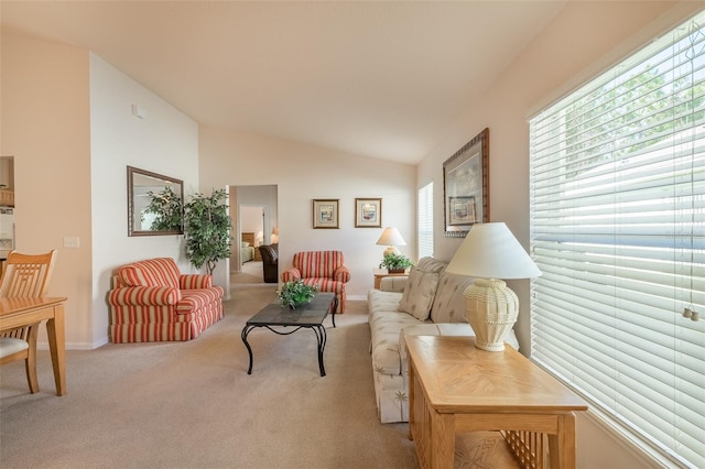 living room with light colored carpet and vaulted ceiling