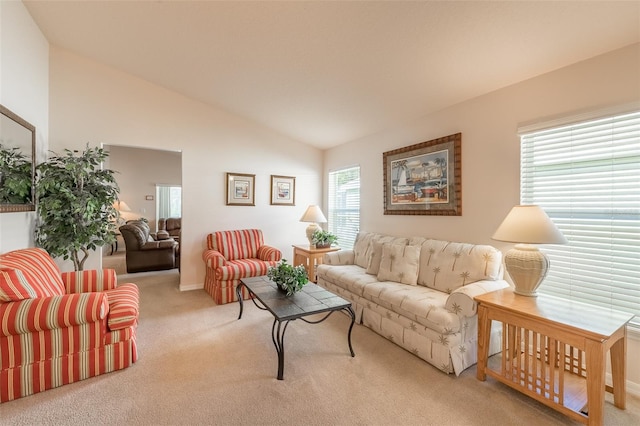 living room with lofted ceiling and light carpet