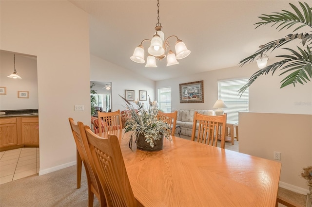 dining room featuring a chandelier, light carpet, and vaulted ceiling