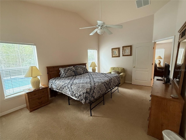 carpeted bedroom featuring high vaulted ceiling and ceiling fan